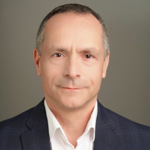 Portrait of investor Bradley Horowitz in front of a grey studio background.