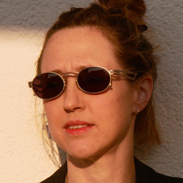 Snapshot-style portrait of New Models founder and culture writer Caroline Busta, wearing sunglasses.
