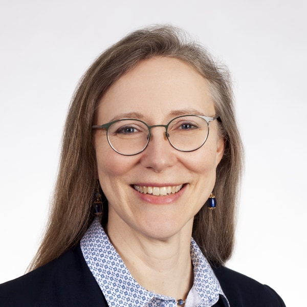 Headshot portrait of space researcher Carolyn van der Bogert, University of Münster, in front of a light grey studio background.