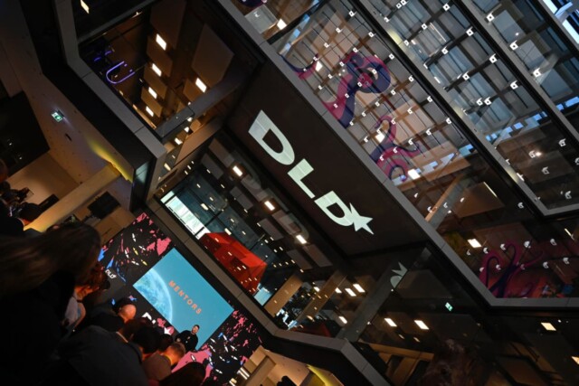 Packed auditorium at DLD Munich conference 2026, tilted by 45 degrees to the right.