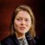 Portrait of BayWa analyst Marie Ammann, speaking at a conference.