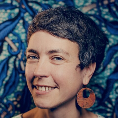 Headshot portrait of French sustainability investor Marie Ekeland in front of a colorful background.