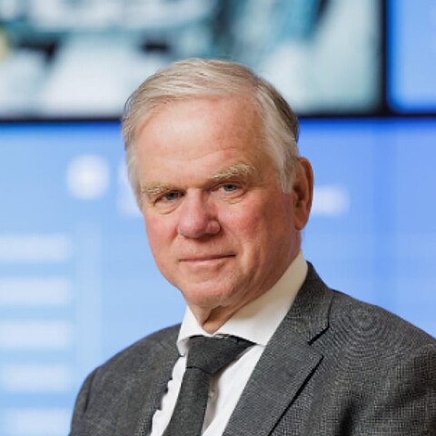 Portrait of longtime ASML executive Martin van den Brink on stage at a conference.