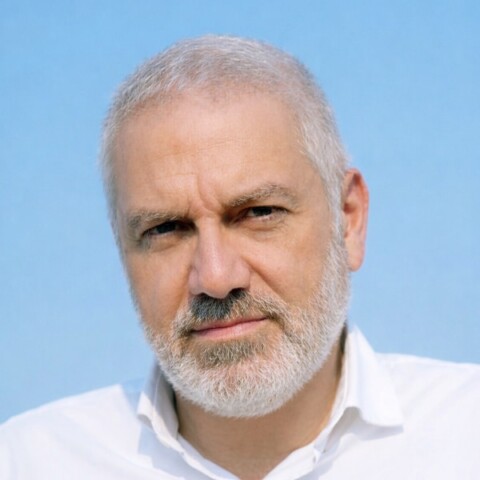 Headshot portrait of Pegor Papazian, TUMO Center for Creative Technologies, in front of a blue background.