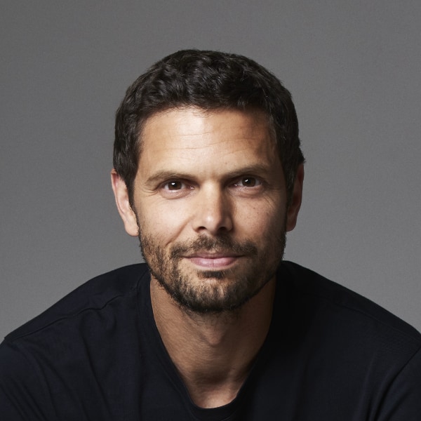 Studio portrait of Peter Sarlin, Silo AI, in front of a grey background.