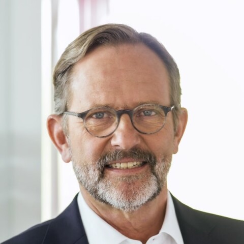 Profile image of Ralf Huss, BioM Biotech Cluster Development, in front of a grey wall