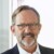 Profile image of Ralf Huss, BioM Biotech Cluster Development, in front of a grey wall