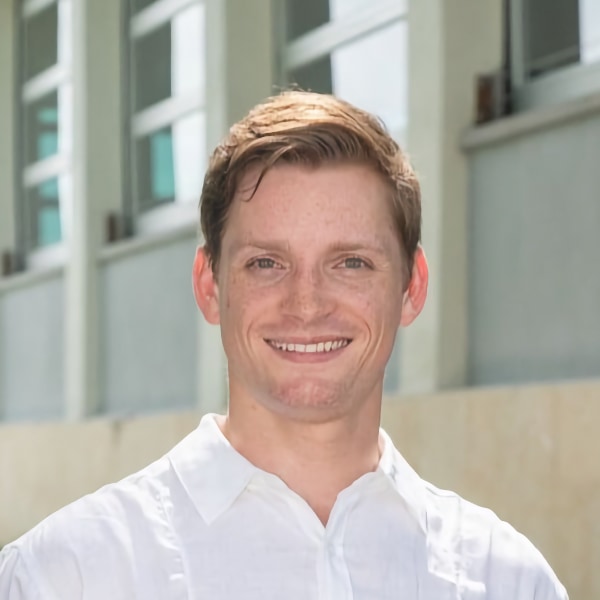 Environmental headshot portrait of Ryan Alicea, Powered Orthotics, in front of a building.