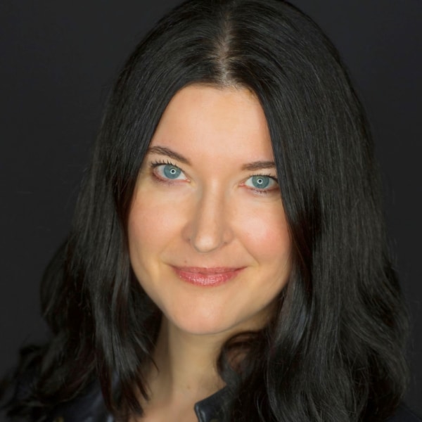 Close-up headshot portrait of Saskia Steinacker, CDO at Springer Nature, in front of a dark studio background.