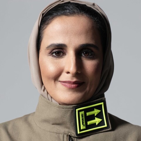 Studio portrait of Her Excellency Sheikha Al Mayassa bint Hamad bin Khalifa Al-Thani, Qatar Museums, wearing a stylish grey outfit.