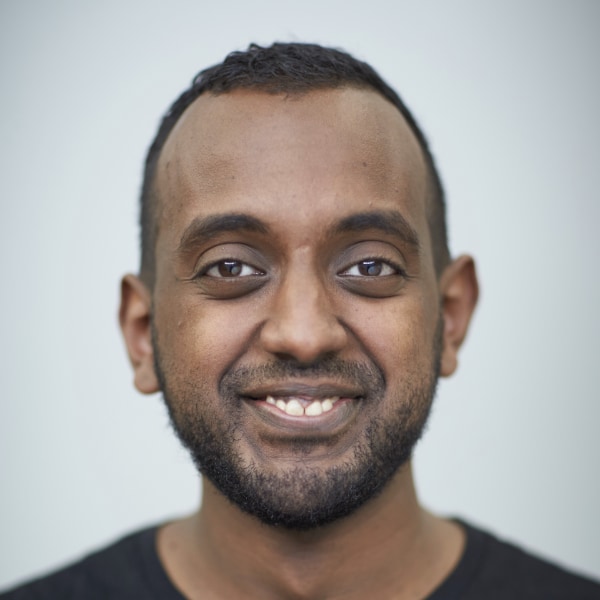 Portrait of Sinksar von Quillfeldt-Ghebremedhin, Netlight, in front of a light grey studio background.