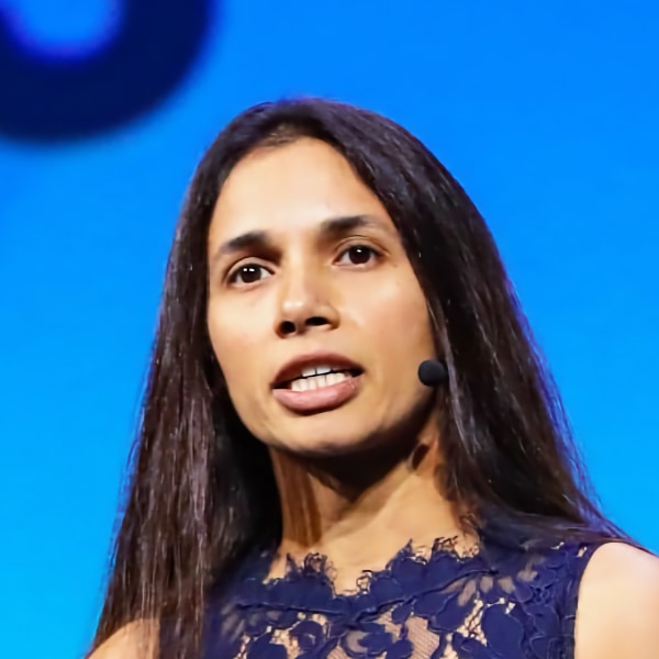 Portrait of Tara Chklovski in front of a blue background.
