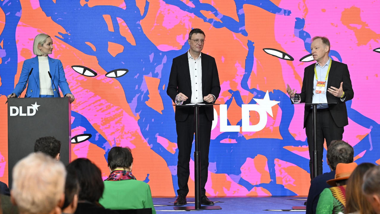Dasha Burns (Politico), Patrick Cramer (Max Planck Society) and Clemens Fuest (Ifo Institute) speaking at the DLD Munich Conference 2026. Credit: Sebastian Gabriel / picture alliance for DLD / Hubert Burda Media