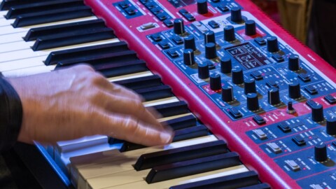Close-up of a hand playing the keyboard at the DLD Munich 2026 conference