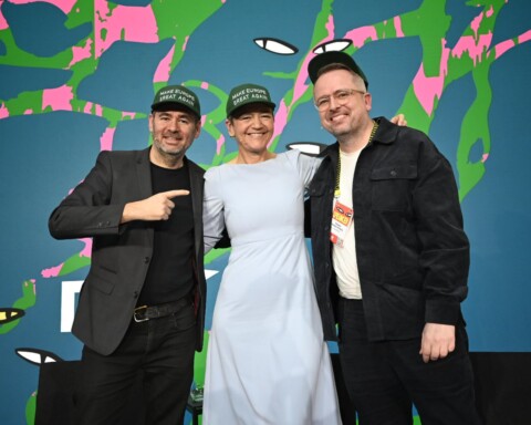 André Loesekrug-Pietri (JEDI initiative), Margrethe Vestager (former EU Commissioner) and Thomas Madsen-Mygdal at DLD Munich 2026, wearing baseball caps saying “Make Europe Great Again”