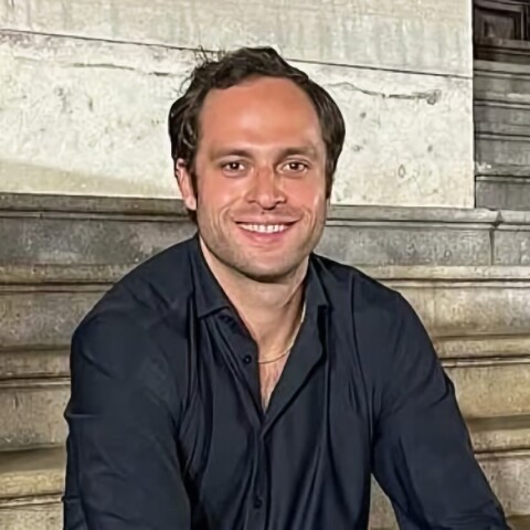 Portrait of Seedbox Labs co-founder and CEO Avery Haskell, sitting on a set of stairs, smiling