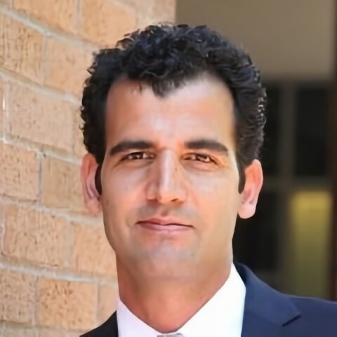 Headshot portrait of Dr. Hadi Shafiee, Harvard Medical School, standing in front of a brick wall