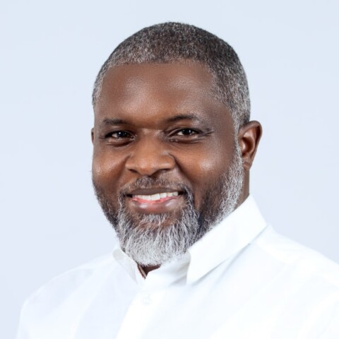 Headshot portrait of scientist John Amuasi (KNUST and Bernhard Nocht Institute) in front of a grey studio background