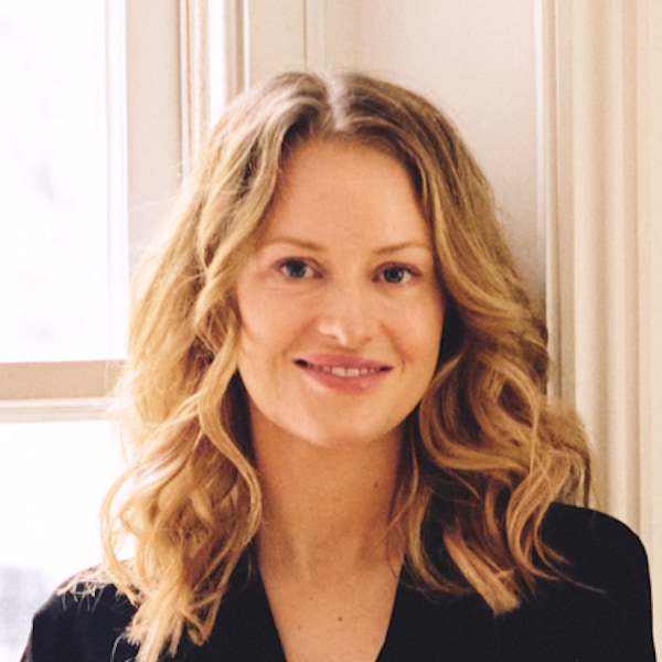 Headshot portrait of Seedbox co-founder Lara Daniel sitting in front of a window, smiling
