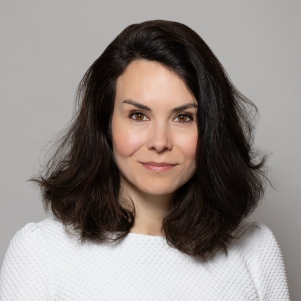 Headshot portrait of investor Nadja Bresous Mehigan, XAnge, in front of a grey studio background