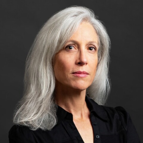 Headshot portrait of former CDC director Dr. Susan Monarez, founder of Heartland Global Strategies, in front of a dark grey studio background