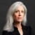Headshot portrait of former CDC director Dr. Susan Monarez, founder of Heartland Global Strategies, in front of a dark grey studio background