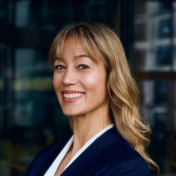 Headshot portrait of EY manager Jasmin Gaertner, smiling, looking over her left shoulder