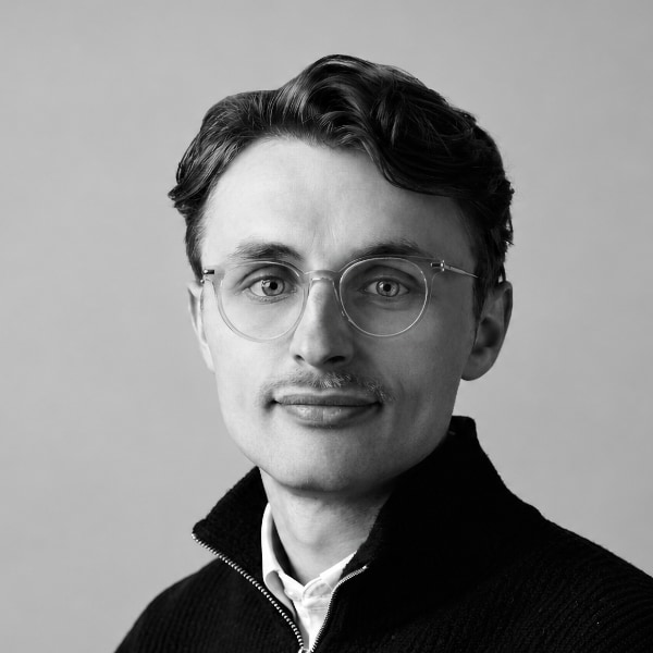 Black and white studio portrait of Ollie Cantrillm, CEO and founder of sports advisory firm Insight Eleven