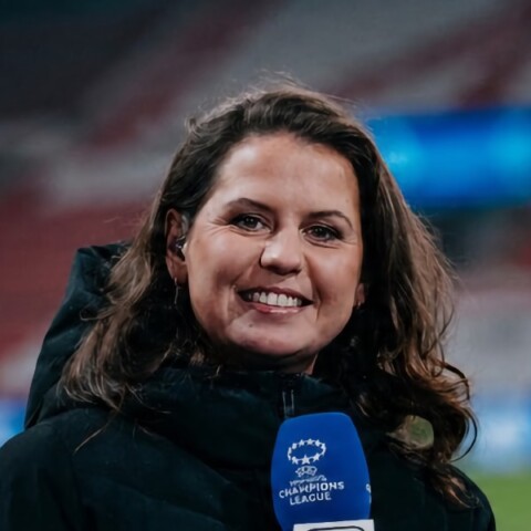 Headshot portrait of Dutch sports presenter Sanne van Dongen, holding a microphone