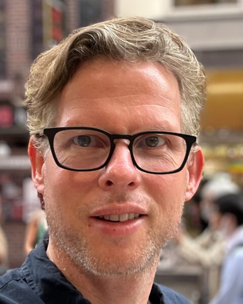 Headshot portrait of Earli CEO Cyriac Roeding, wearing black-rimmed glasses, smiling at the camera.