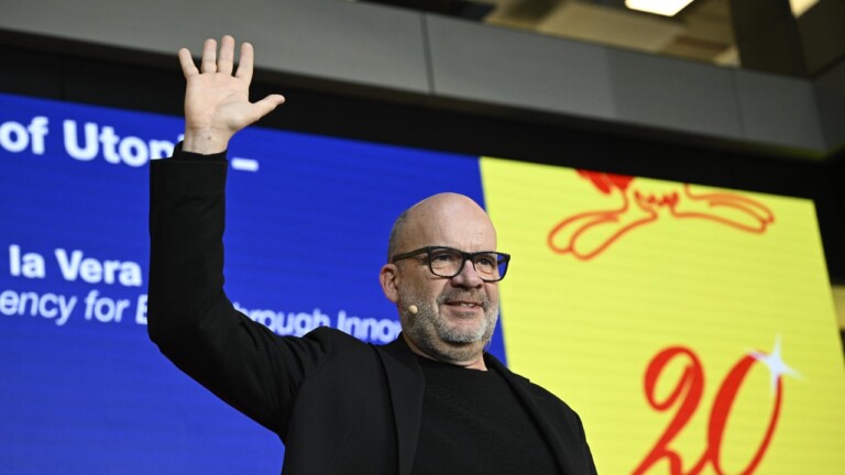 Rafael Laguna de la Vera (SPRIND) on stage at the DLD Munich Conference 2025, raising is right arm, smiling at the audience.