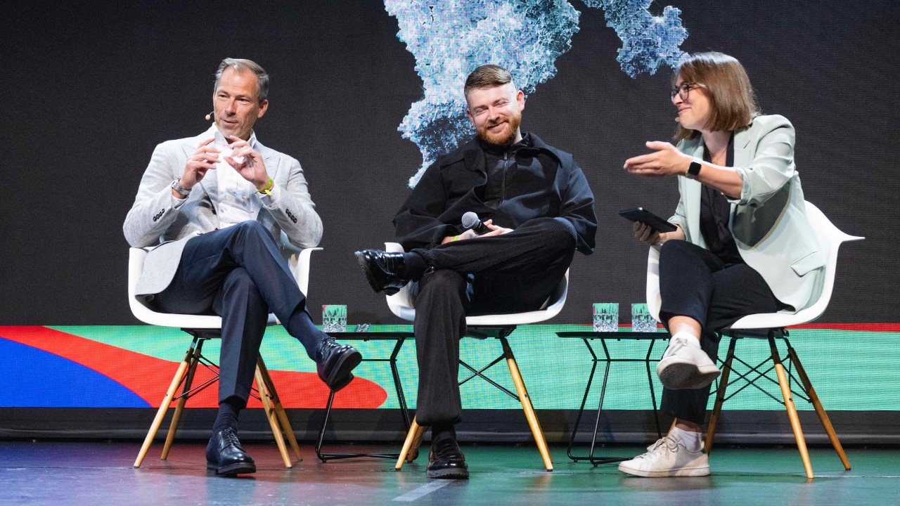 Left to right: Anders Warming (BMW Group), Harry Yeff (Reeps100 Studio) and Larissa Holzki (Handelsblatt) on stage at the DLD Future Hub conference in Munich.